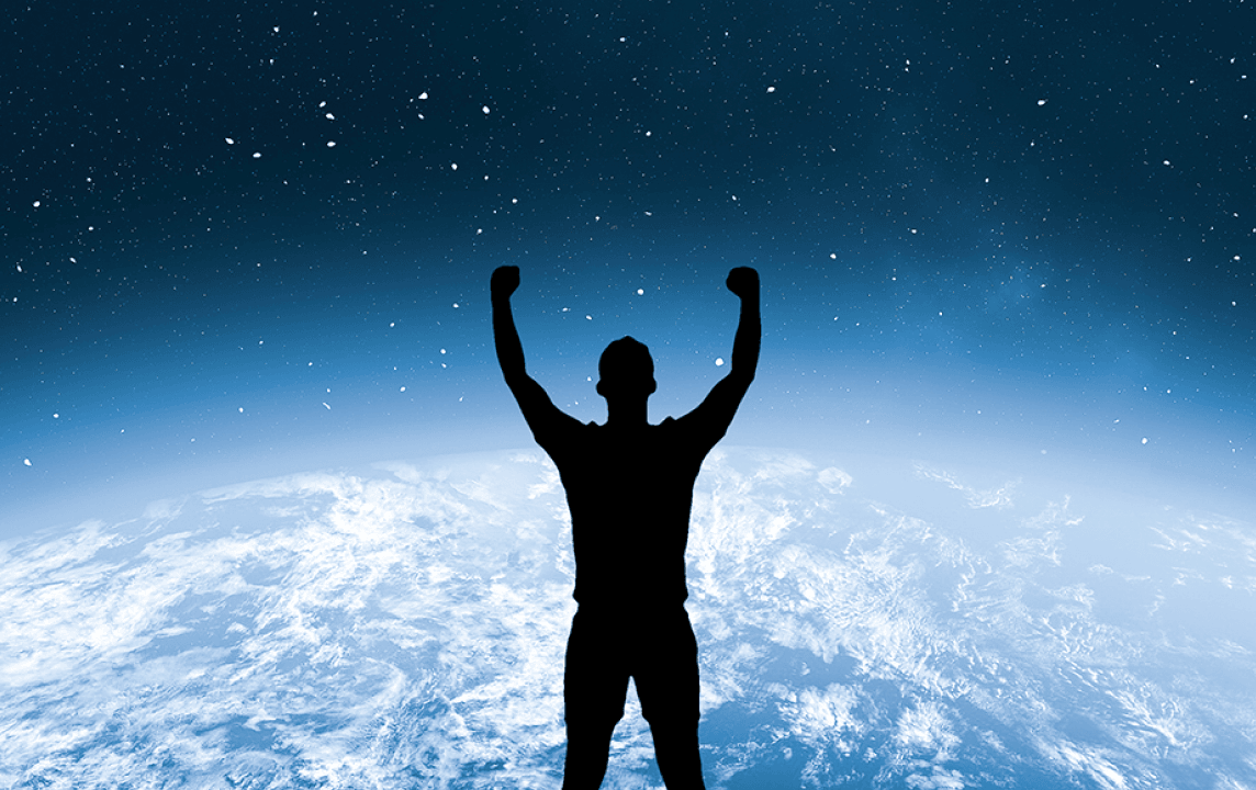 Man silhouetted against an illuminated globe